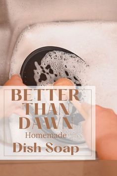 a person washing dishes in a sink with the words better than dawn homemade dish soap