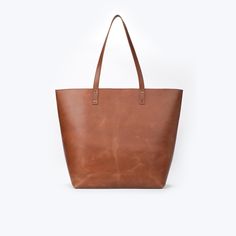 Product Overview: Upgrade your style with our handmade brown leather tote bag, crafted with care to meet your everyday needs. This stunning tote features luxurious lambskin leather, offering a combination of durability and sophistication. Perfect for daily commutes, shopping trips, or as a chic addition to your wardrobe, this tote is the definition of effortless style and function. Premium Quality Leather: Crafted from high-quality lambskin leather, this tote not only offers a sleek and polished Brown Bags For Fall, Brown Smooth Grain Bags For Fall, Large Capacity Brown Leather Bag, Brown Bags With Leather Lining For Everyday Use, Brown Leather Lined Everyday Bag, Brown Leather Lining Bags For Everyday, Brown Leather Bag For Everyday Use, Everyday Brown Bags With Leather Lining, Dark Tan Leather Bag For Everyday Use