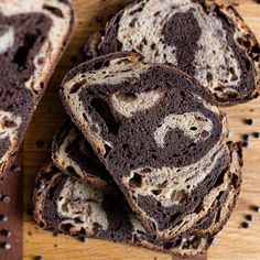 several pieces of bread sitting on top of a wooden cutting board