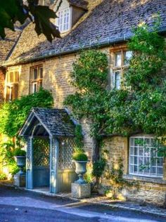 an old stone house with ivy growing on it