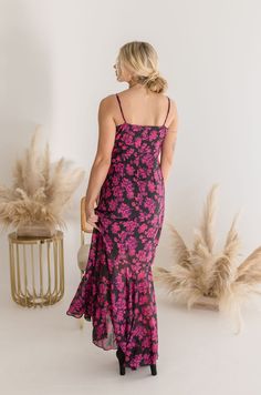 Stand out from the crowd in the fun and flirty Toya dress! This stunning fuchsia maxi features a bold floral print and an asymmetrical ruffle skirt for a playful twist. Perfect for spring and summer weddings. Details & Fit: 100% Polyester Runs True to Size Hand Wash Cold Hang To Dry V-Neckline Sleeveless Adjustable Straps Back Zipper Closure Asymetrical Ruffle Skirt Lined Floral Print Design Fuchsia | Black | Printed Model is 5'9" and wearing a size Small Flirty Ruffle Hem Maxi Dress For Garden Party, Flirty Maxi Dress With Ruffle Hem For Garden Party, Flirty Midi Length Maxi Dress With Floral Print, Pink Ruffle Hem Maxi Sundress, Pink Ruffle Hem Sundress Maxi Dress, Flirty Sleeveless Maxi Dress For Garden Party, Summer Flirty Maxi Dress With Ruffled Skirt, Pink Maxi Dress With Ruffle Hem, Pink Ruffled Skirt Maxi Dress For Spring