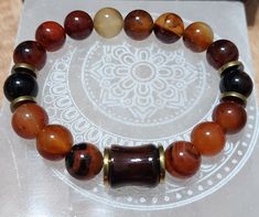 It’s Day 11 of our "30 Days of Semiprecious Gemstone Joy" journey. Today's Joy is "Autumn Radiance.” Immerse yourself in the warm embrace of our Day 11 bracelet, "Autumn Radiance." Crafted with exquisite 12mm shades of burnt orange agate beads, this limited-edition piece features a captivating carnelian agate focal bead. Gold hematite spacers add a touch of elegance to this harmonious ensemble, creating a bracelet that radiates the soothing energy of ember glow. Designed to fit wrists measuring Brown Hand Wrapped Stretch Bracelet Gift, Brown Hand Wrapped Stretch Bracelet For Gift, Spiritual Brown Round Beaded Bracelets, Handmade Spiritual Brown Stretch Bracelet, Brown Gemstone Healing Bracelets, Brown Gemstone Bracelets For Healing, Brown Spiritual Bangle Jewelry, Brown Gemstone Beads Bracelet As Gift, Adjustable Brown Carnelian Bracelets