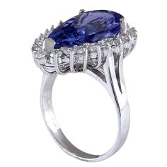 Stamped: 14K White Gold Total Ring Weight: 6.4 Grams Gemstone Weight: Total Natural Tanzanite Weight is 6.36 Carat (Measures: 17.75x9.60 mm) Color: Blue Diamond Weight: Total Natural Diamond Weight is 0.90 Carat Quantity: 21 Color: F-G, Clarity: VS2-SI1 Face Measures: 22.40x15.30 mm Sku: [702046W] Formal Tanzanite Diamond Ring, Oval Shape, Oval Tanzanite Diamond Ring For Formal Occasions, Formal Tanzanite Diamond Ring Oval Shape, Formal Oval Tanzanite Diamond Ring, Oval Tanzanite Ring For Formal Occasions, Formal Oval Tanzanite Ring, 14k White Gold Pear-shaped Formal Ring, Formal 14k White Gold Pear-shaped Ring, Formal Gia Certified Pear-shaped Rings