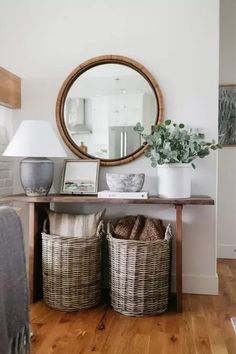 a table with two baskets under a mirror