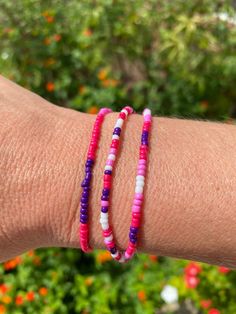 Layer up these three fun bracelets. Each is a different pattern. Colors are magenta, pink, purple and white. Made with a stretchy band for easy use. Bracelet Making Ideas, Instagram Feed Organizer, Bracelet Trio, Ombre Bracelet, Beaded Patterns, Magenta Rose, Fun Bracelet, Bead Ideas, Magenta Pink