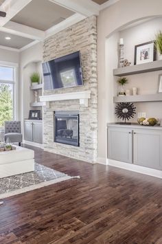 a living room with white furniture and a fireplace