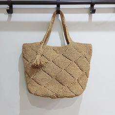 a straw bag hanging on a wall