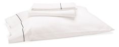 the white sheets and pillowcases are neatly folded on top of eachother