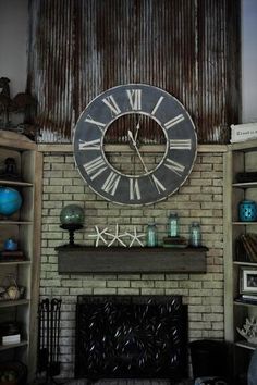 a large clock mounted to the side of a brick wall next to a fire place