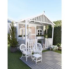 a white gazebo sitting on top of a lush green field next to a house