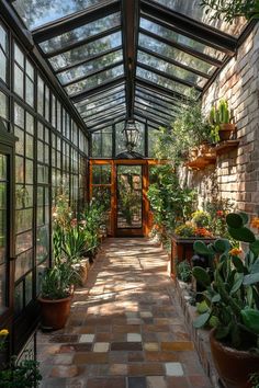 the inside of a greenhouse with lots of plants and potted plants on either side