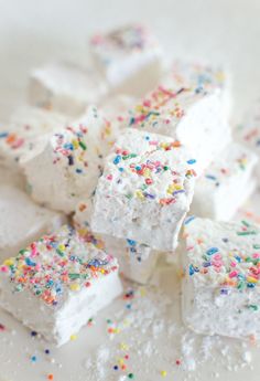 white marshmallows with sprinkles and colored powdered sugar on top