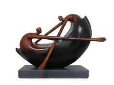 a sculpture of two people riding on a boat