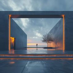 a person standing in an open space with lights on either side of the entrance and trees