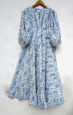 "ITEM DESCRIPTION blue floral printed cotton umbrella maxi dress - Henley neckline with button maxi dress - 3/4th sleeve with button maxi dress Features: 3/4th sleeve, Henley neck, Long dress Material: Cotton cambric Fabric: 100% cotton soft light weight ethnic print fabrics  Sleeve Length = 18 inch For more sizes & their measurement, please refer our below chart to understand the sizes variations available with us For your size requirement, please mention your size in seller note at the time of buying. SIZE MEASUREMENT  BUSTLENGTHSHOULDER XXS34 inch51 inch13.5 inch XS36 inch51 inch14 inch S38 inch51 inch14.5 inch M40 inch51 inch15 inch L42 inch51 inch16 inch XL44 inch51 inch16.5 inch 2XL46 inch51 inch17 inch 3XL48 inch51 inch18 inch   Company Return Policy:  Please write for more informat Bohemian Light Blue Cotton Maxi Dress, Light Blue Bohemian Maxi Dress For Daywear, Umbrella Maxi Dress, Button Maxi Dress, Cotton Long Dress, Fashion Top Outfits, Bohemian Maxi, Fancy Dress Design, Ethnic Print