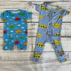 Two Bamboo Rompers From Bums And Roses, Previously Known As Little Bum Bums. Both Short Sleeve, Size 12-18 Months. Submarine Print Is Long Pants, Never Worn. “Ready Jet Go” Set Is Shorts And Only Worn Once. Both Excellent Quality. Fun Cartoon Print Onesie For Playtime, Yellow Onesie With Cartoon Print For Playtime, Playful Yellow Onesie For Loungewear, Yellow Cartoon Print Onesie For Playtime, Cute Blue Onesie For Playtime, Casual Yellow Onesie For Playtime, Fun Short Sleeve Summer Onesie, Yellow Onesie For Playwear, Playful Blue Onesie With Cartoon Print