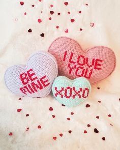 three crocheted hearts with i love you written on them