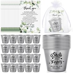 a set of twelve shot glasses with wedding favors and thank you note card in the background