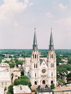 an aerial view of a church in the middle of a city with tall spires