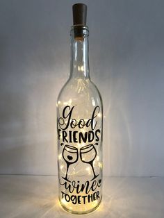 a glass bottle with lights in it that says good friends, wine is toother