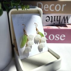 Handmade Lily flower dangle earrings are made with resin flowers, resin leaves and 14K gold plated ear hooks which are hypoallergenic. Size: The multi flowers(W x L) is about 1.5cm x 4.5cm They single flower(W x L) is about 0.8cm x 4.5cm Resin Leaves, Flowers Resin, Flower Dangle Earrings, Resin Flowers, Single Flower, Ear Hook, Lily Flower, White Roses, Dangle Earrings