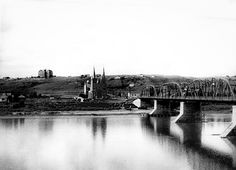 black and white photograph of a bridge over water