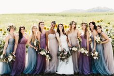 a group of women standing next to each other in front of some sunflowers