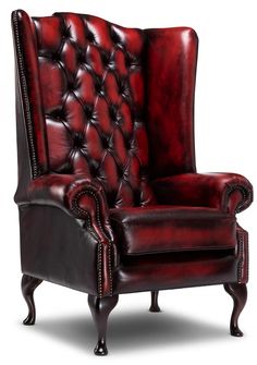 a red leather chair with nail polishing on the armrests and foot rest