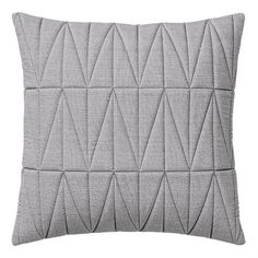 a gray pillow with an abstract design on it