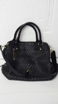 This Auction is for a Brand New with Tags NILA ANTHONY WOVEN SATCHEL BLACK HANDBAG WITH CHAIN HANDLE.   Top zipper closure. Measures approx. 12" Height, 15" Length, 5" Width. Faux black leather with weave design. Gold tone metal. 1 exterior pocket. Lining: polyester. 3 pockets inside. One of the pockets is sized to hold a cell phone. Attachable gold tone and faux black leather woven through gold tone chain hand carry strap: 6" drop. Two fixed hand carry straps have a 6” drop. Additional attachab Top Handle Satchel With Handles As Fashion Accessory, Black Rectangular Satchel Fashion Accessory, Chic Tote Hobo Bag, Modern Satchel Shoulder Bag, Black Shoulder Bag As Fashion Accessory, Black Satchel With Braided Handles, Black Satchel With Braided Handles For Daily Use, Modern Shoulder Satchel, Black Satchel With Detachable Strap