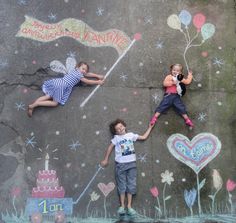 two children laying on the ground with chalk drawings