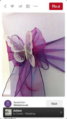 a purple butterfly decoration sitting on top of a chair