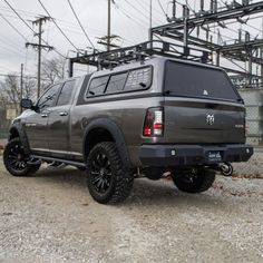 a large gray truck parked on top of a gravel road