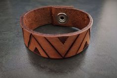 African styled Leather Bracelet, African styled Leather band, handmade using locally sourced Cow leather, Hand tooled and tanned a 'tan' brown colour. Sizes range from 6 inches (~15 cm) to 10 inches (~25 cm). Not sure if it will fit? Take a piece of string or a strip of paper and wrap it around your wrist. Take the measurement of the paper at the fit that would be most comfortable for you. Usually leaving a finger between your wrist and cuff or bracelet would fit nicely. The length provided in t Adjustable Brown Wristband For Everyday Use, Adjustable Hand Tooled Brown Leather Bracelet, Adjustable Hand-tooled Brown Leather Bracelet, Handmade Brown Cuff Bracelets, Brown Handmade Cuff Bracelets, Handmade Distressed Brown Adjustable Bracelet, Hand Tooled Brown Leather Bracelets, Brown Leather Hand-tooled Bracelets, Unique Brown Leather Bracelets