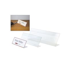 two clear plastic business cards on a wooden table with the name peter miller printed on them