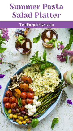 a plate with asparagus, tomatoes and other vegetables