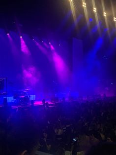 the stage is lit up with purple and blue lights