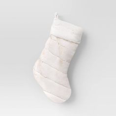 a white christmas stocking hanging on a wall