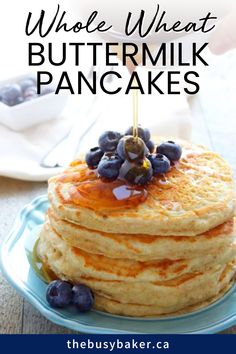 a stack of pancakes with blueberries on top and the words whole wheat buttermilk pancakes