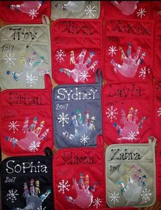 a quilted wall hanging with handprints and snowflakes on red fabric