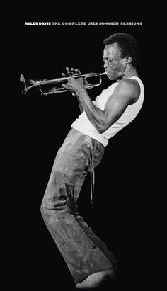 a man playing a trumpet in front of a black background