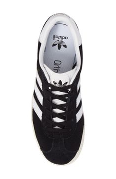 Initially designed as a training shoe for top athletes in 1991, the iconic adidas Gazelle sneaker has been refreshed with a sleek, narrower silhouette but retains the classic 3-Stripes and heel tab of the original. Lace-up style Removable OrthoLite® insole Leather and synthetic upper/textile and synthetic lining/rubber sole Imported Kids' Shoes Adidas Sneakers For Skateboarding, High-top Tennis Sneakers With Laces, Adidas Tennis Sneakers With White Sole, Black Round Toe Tennis Sneakers, Black High-top Tennis Sneakers, Adidas High-top Tennis Sneakers, Adidas High-top Sneakers For Tennis, Adidas Mid-top Sneakers, Adidas Kids