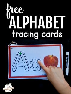 a hand holding an apple with the letter a in front of it and text that reads free alphabet tracing cards