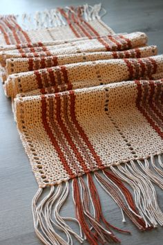 three pieces of woven fabric with red and white stripes