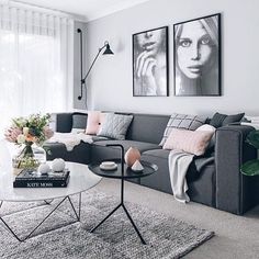 a living room with two pictures on the wall and a coffee table in front of it