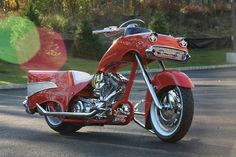 a red motorcycle is parked on the street