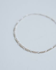 The slim, dainty figaro chain features high-quality sterling silver for a timeless, minimalist style that'll never go out of fashion. Invest in a life-long piece of jewelry you'll love forever! ∙ D E T A I L S ∙ - Dainty Figaro Chain- 925 Stamped Sterling Silver- Custom fit to your wrist ∙ STERLING ∙ SILVER ∙ Sterling silver is a metal alloy created by combining 92.5% pure silver with 7.5% other metals, typically copper. While Sterling Silver may darken due to oxygen exposure it can easily be polished without damaging the metal itself. You should even be able to pass your silver jewellery on to future generations! Figaro Bracelet, Figaro Chains, Figaro Chain, Love Forever, Silver Jewellery, Pure Silver, Minimalist Style, Sterling Silver Bracelets, Custom Fit