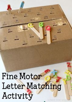 a cardboard box with clothes pins and letters on it that spell out the word fine motor letter matching activity