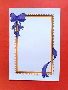 a card with a blue ribbon and bow on the front, against a red background