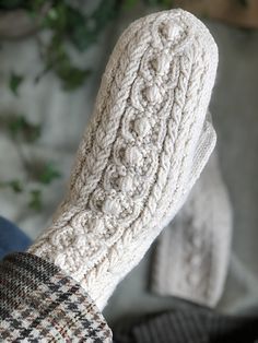 a person's feet wearing white knitted socks